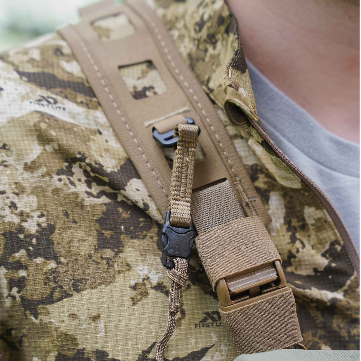 Padded tan FHF harness with tan mesh, buckles over a camo jacket.