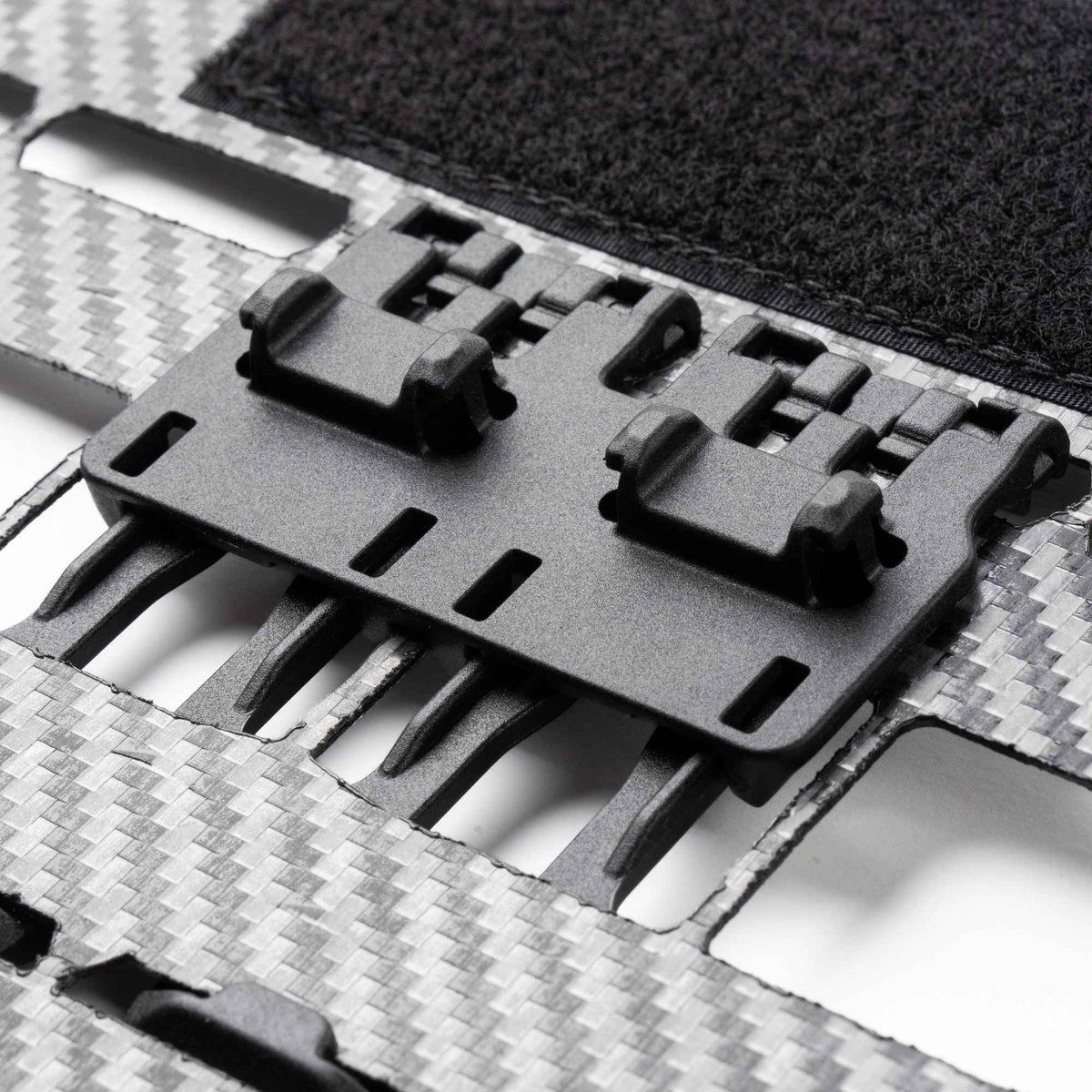 Black FHF Snapcor buckle mounted on a gray multi-point webbing strap.