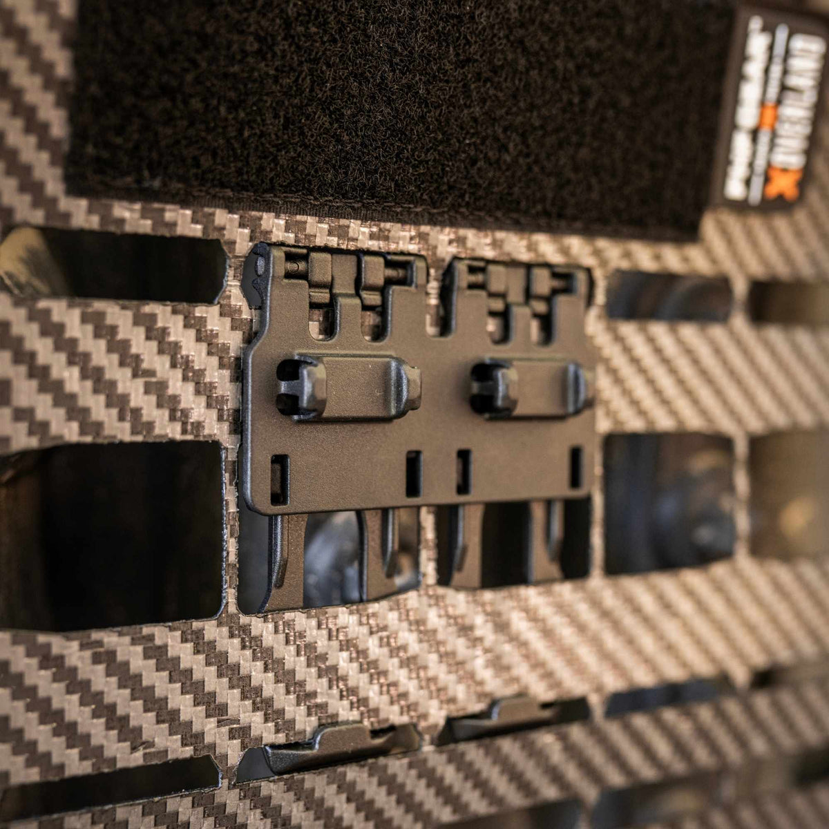 Close look at an FHF Snapcor buckle mounted on the MOLLE grid of The Bulkhead,