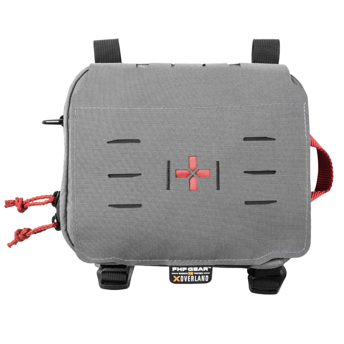 Grey medical kit with black straps aobe and below it, orange cords on zippers, an orange strap on the side, an orange cross in the middle and a tag beneath with FHF GEAR XOVERLAND branding.