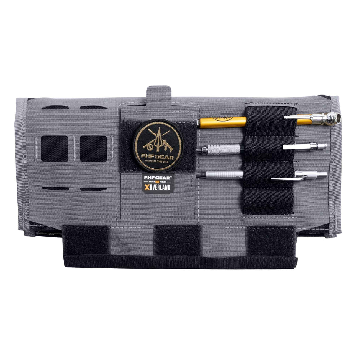 Gray car visor organizer with pens on the black elastics, velcro, FHF GEAR logo in light brown and "FHF GEAR XOVERLAND" branding in the middle.