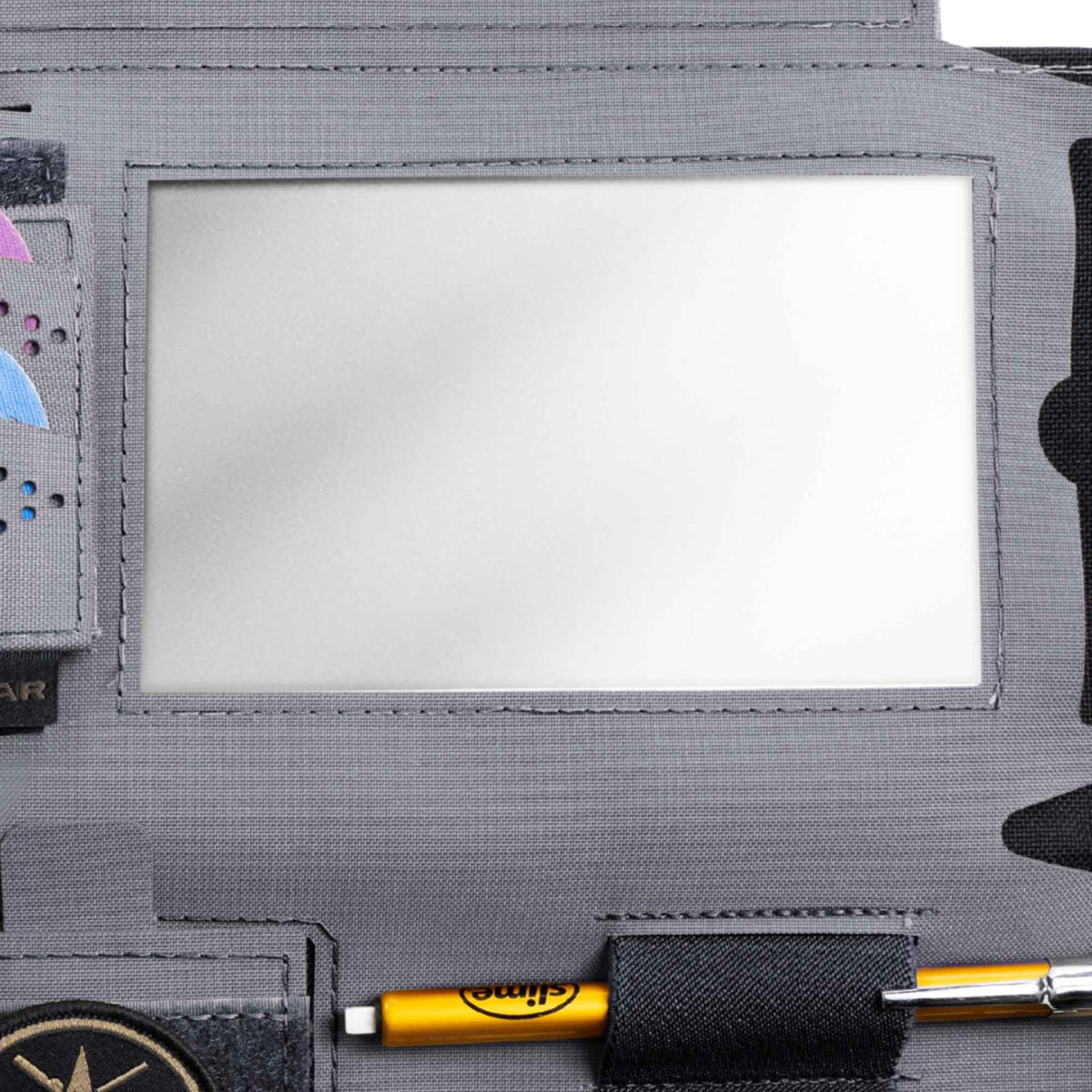 Clear vinyl window of a grey The Horizon Visor Organizer.