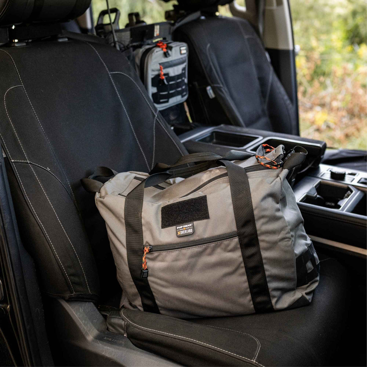 Grey FHF The Stage Tote on a black seat inside of a van.
