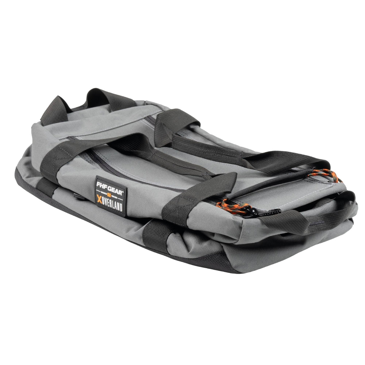 Folded down FHF The Stage Tote in grey with black straps, orange cords on zippers and FHF XOVERLAND branding.
