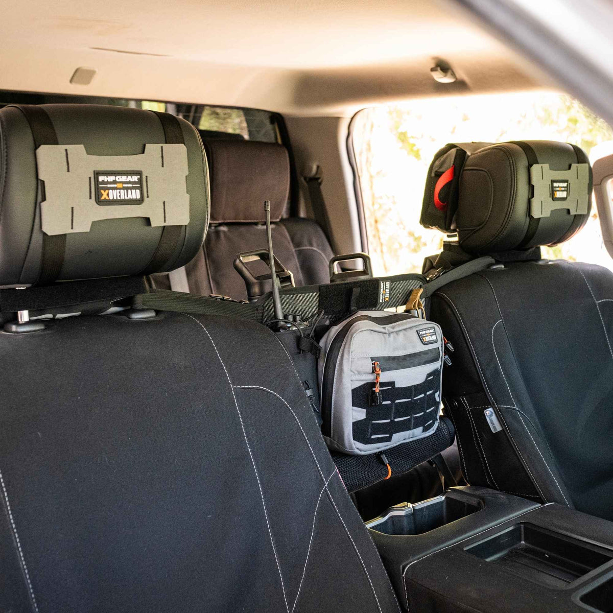 Grey Waypoint GP Pouch mounted between two front seats.