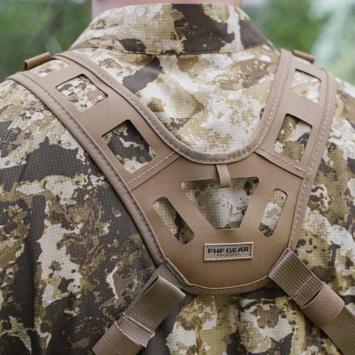 Tan FHF GEAR mesh harness worn over a camouflage jacket.