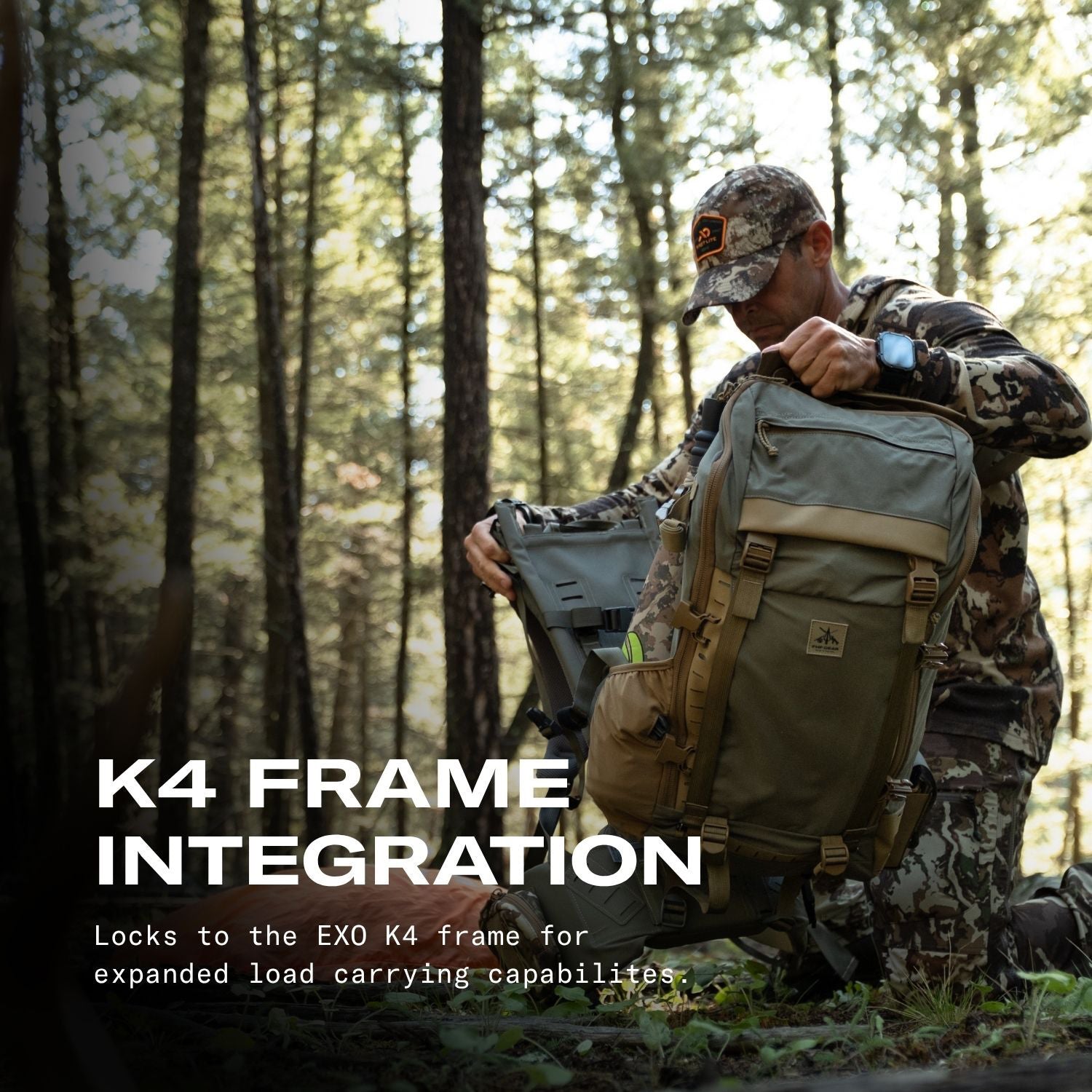 A man in camouflage clothing kneels in a forest while demonstrating a large outdoor backpack with attached gear. Large overlaid text reads 'K4 FRAME INTEGRATION' with smaller descriptive text below.
