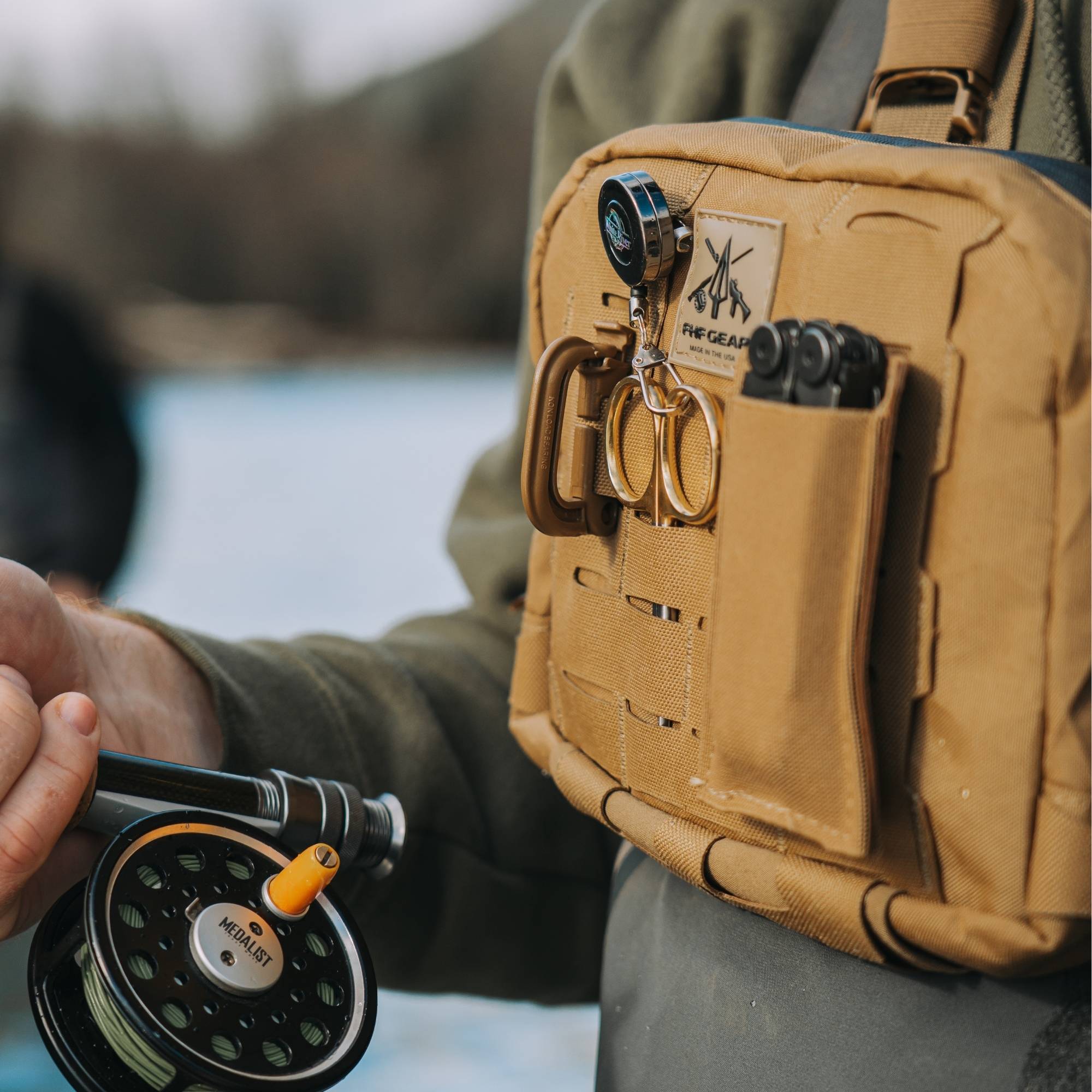 Man wearing FHF Gear chest rig and a fishing rod in his right hand.