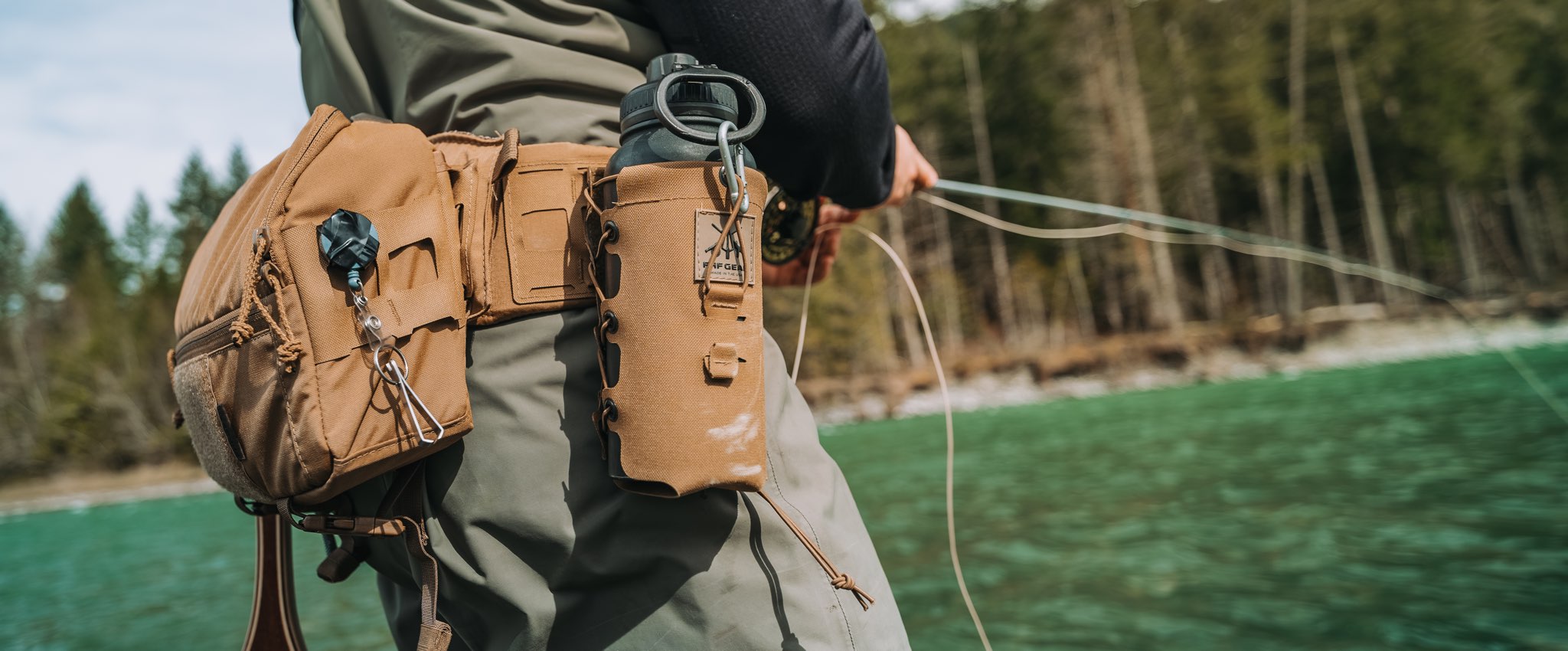 Person holding a fishing rod with a lumbar pack in a forest setting