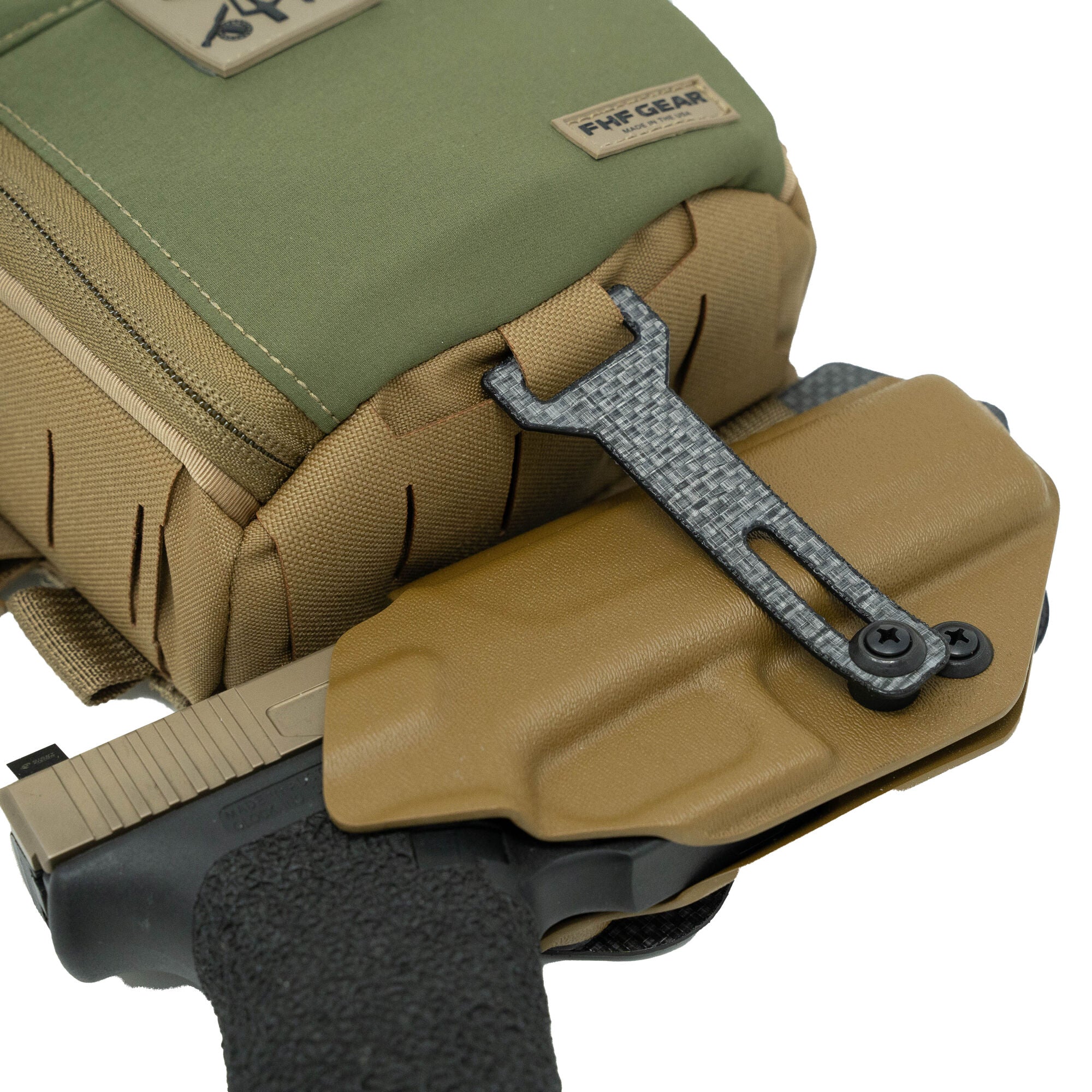 Green & coyote pouch with tan holster secured by carbon fiber strap, holding a black & tan pistol.